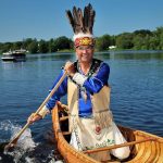 Image of Reuben Phillips paddling a canoe