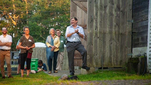 Senate President Troy Jackson laughs at remarks at the event. Senate President Troy Jackson laughs and claps hands with a small crowd looking on